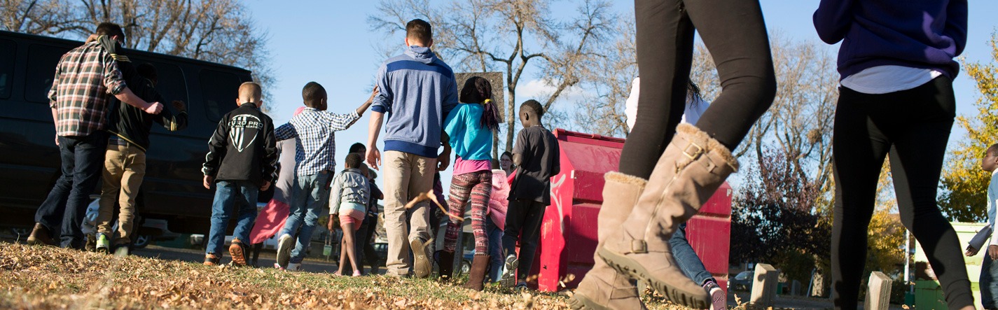 Group of kids walking away outside with Club staff