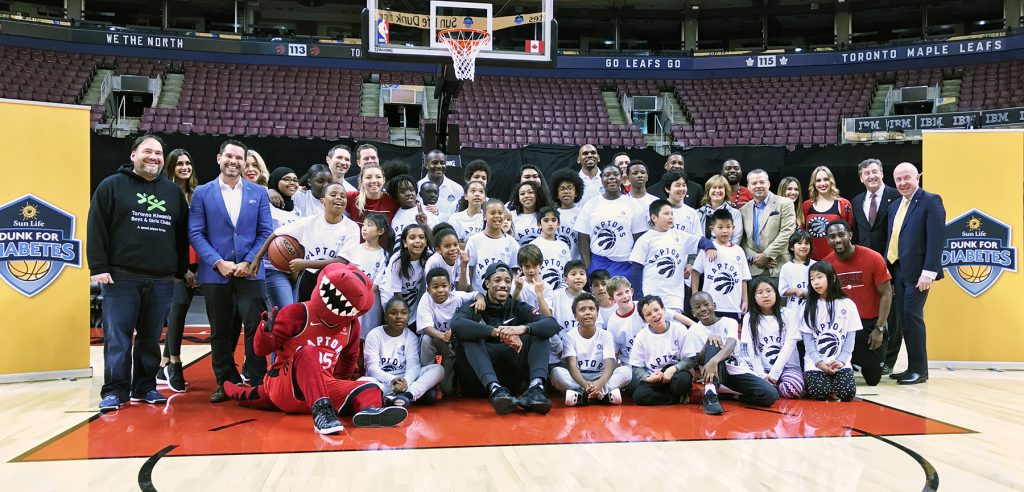 Group shot of Club staff and kids with Toronto Raptors